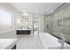 Modern bathroom with a soaking tub, glass-enclosed shower, and sleek floating vanity at 662 Manchester Dr, Raleigh, NC 27609