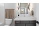 Well-lit bathroom with a modern vanity, decorative mirror, and convenient towel racks at 662 Manchester Dr, Raleigh, NC 27609