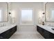 Symmetrical bathroom featuring dual vanities, contemporary lighting, and a frosted window at 662 Manchester Dr, Raleigh, NC 27609