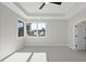 Bright bedroom with tray ceilings and large windows providing natural light and outdoor views at 662 Manchester Dr, Raleigh, NC 27609