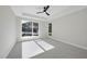 Neutral bedroom with large windows providing natural light, and modern ceiling fan at 662 Manchester Dr, Raleigh, NC 27609