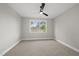 Bright bedroom with scenic views through a large window and neutral carpet at 662 Manchester Dr, Raleigh, NC 27609