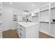 Bright walk-in closet with custom shelving, storage island, wood floors, and modern lighting fixtures at 662 Manchester Dr, Raleigh, NC 27609