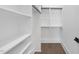 Walk-in closet featuring custom shelving and hanging rods for organized storage at 662 Manchester Dr, Raleigh, NC 27609