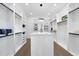 Bright walk-in closet with custom shelving, storage island, wood floors, and modern lighting fixtures at 662 Manchester Dr, Raleigh, NC 27609