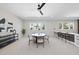 Bright dining area with a round table set, large windows, and a modern bar area at 662 Manchester Dr, Raleigh, NC 27609