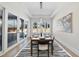 Elegant dining room with natural light, modern chandelier, setting for eight, and stylish rug at 662 Manchester Dr, Raleigh, NC 27609