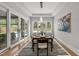 Bright dining room featuring modern light fixture, and sliding glass doors leading to outdoor pool at 662 Manchester Dr, Raleigh, NC 27609