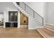Stylish entryway features modern staircase, wet bar, wine refrigerator, and hardwood floors at 662 Manchester Dr, Raleigh, NC 27609