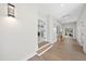Inviting hallway featuring wood floors, neutral walls and doors leading into other rooms at 662 Manchester Dr, Raleigh, NC 27609