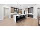 Bright kitchen featuring a large island with seating, stainless steel appliances, and modern cabinetry at 662 Manchester Dr, Raleigh, NC 27609