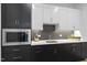 Modern kitchen featuring custom cabinets, stainless steel microwave and sleek countertop at 662 Manchester Dr, Raleigh, NC 27609