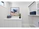 Well-organized laundry room showcases a counter, storage, and wall art enhancing a modern space at 662 Manchester Dr, Raleigh, NC 27609