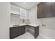 Well-organized laundry room with ample cabinet space and a convenient folding counter at 662 Manchester Dr, Raleigh, NC 27609