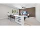 Cozy living area featuring a modern white sofa, unique artwork, and a functional bar setup at 662 Manchester Dr, Raleigh, NC 27609