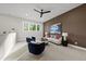 Modern living room showcasing plush seating, a contemporary ceiling fan, and neutral carpet at 662 Manchester Dr, Raleigh, NC 27609