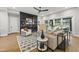 Open concept living room with modern fireplace, neutral decor and a view to the outdoor kitchen at 662 Manchester Dr, Raleigh, NC 27609