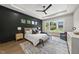 Well-lit main bedroom with striking accent wall and expansive windows for natural light at 662 Manchester Dr, Raleigh, NC 27609