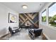 Stylish office with unique wood accent wall, modern lighting, desk, and comfortable chairs at 662 Manchester Dr, Raleigh, NC 27609