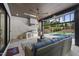 Covered outdoor kitchen and lounge with a full kitchen setup and view of the pool at 662 Manchester Dr, Raleigh, NC 27609