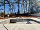 Unfinished in-ground pool with tile surround and new fence in a wooded backyard at 662 Manchester Dr, Raleigh, NC 27609
