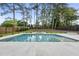 Beautiful backyard pool with a spa, surrounded by lush greenery and a modern fence for privacy, perfect for outdoor enjoyment at 662 Manchester Dr, Raleigh, NC 27609