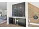 Modern wet bar with black cabinetry, wine storage, and stylish wood accent wall at 662 Manchester Dr, Raleigh, NC 27609