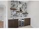 Elegant wet bar area with marble backsplash, floating shelves, and a wine fridge at 662 Manchester Dr, Raleigh, NC 27609