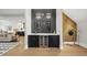 Elegant wet bar featuring custom cabinetry, marble countertops, and wine storage at 662 Manchester Dr, Raleigh, NC 27609