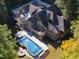 Stunning aerial view of the large home, showcasing the pool, hot tub, and surrounding greenery at 3105 Cone Manor Ln, Raleigh, NC 27613