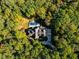A distant aerial view shows the home nestled among trees with a pool and circular driveway visible at 3105 Cone Manor Ln, Raleigh, NC 27613