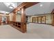 Expansive basement with wood beams, built-in shelving, and a cozy fireplace at 3105 Cone Manor Ln, Raleigh, NC 27613