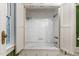 Bright bathroom features a tub/shower combination with marble surround, complemented by white cabinetry at 3105 Cone Manor Ln, Raleigh, NC 27613