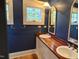 Stylish bathroom with dual sinks, wood countertops, and ample mirror space at 3105 Cone Manor Ln, Raleigh, NC 27613