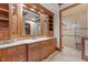 Elegant bathroom features custom wood cabinetry, granite counters, and a glass shower at 3105 Cone Manor Ln, Raleigh, NC 27613
