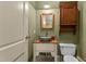 Unique bathroom with a wooden cabinet and bowl sink and a vintage mirror at 3105 Cone Manor Ln, Raleigh, NC 27613