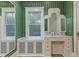 Stylish bathroom boasts green wallpaper, a vanity with marble counters, and decorative windows at 3105 Cone Manor Ln, Raleigh, NC 27613