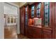 Charming butler's pantry with rich wood cabinetry, sink, and leaded glass doors at 3105 Cone Manor Ln, Raleigh, NC 27613
