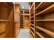 Custom walk-in closet offers generous storage with built-in shelving, drawers, and hanging rods at 3105 Cone Manor Ln, Raleigh, NC 27613