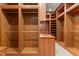 Custom walk-in closet offers ample storage with built-in shelving, drawers, and hanging rods at 3105 Cone Manor Ln, Raleigh, NC 27613