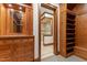 Expansive walk-in closet provides abundant storage with custom cabinetry and shelving with an ensuite bathroom at 3105 Cone Manor Ln, Raleigh, NC 27613