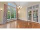 Dining room with large window, hardwood floors, and stylish chandelier at 3105 Cone Manor Ln, Raleigh, NC 27613