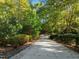 Long private driveway leading up to the home through a lush green landscape at 3105 Cone Manor Ln, Raleigh, NC 27613