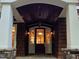 Inviting front entrance featuring a covered porch, stone columns, and a stylish front door at 3105 Cone Manor Ln, Raleigh, NC 27613