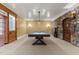 Spacious game room features a billiard table, stone accent wall, and custom woodwork at 3105 Cone Manor Ln, Raleigh, NC 27613
