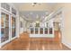 Open-concept kitchen with hardwood floors, white cabinetry, and a view of the staircase at 3105 Cone Manor Ln, Raleigh, NC 27613