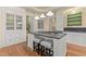 Stylish kitchen island with cooktop and barstool seating, adjacent to custom cabinetry at 3105 Cone Manor Ln, Raleigh, NC 27613