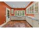 Charming kitchen with a farm sink, white cabinets, and bright terracotta tiled flooring at 3105 Cone Manor Ln, Raleigh, NC 27613