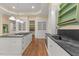 Well-lit kitchen with an island, stone countertops, a chef range, and custom cabinetry at 3105 Cone Manor Ln, Raleigh, NC 27613