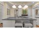 Close-up of a kitchen island with cooktop, counter seating, and custom storage solutions at 3105 Cone Manor Ln, Raleigh, NC 27613